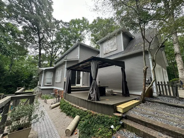 Raised rear deck with a curtained pergola, mid-way through exterior work