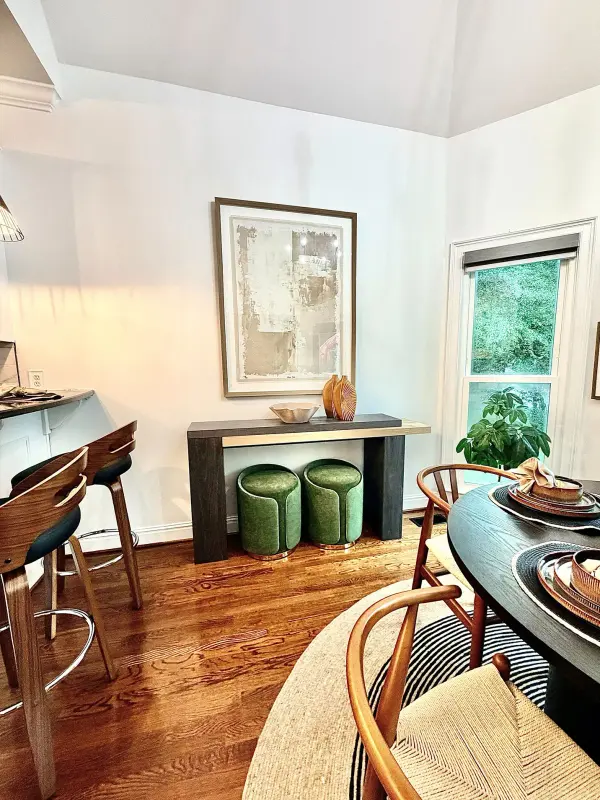 Dining area with red oak flooring and white walls