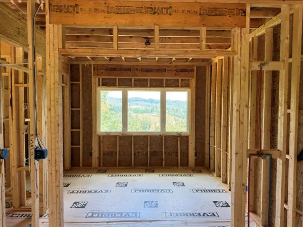 Framing and housewrap around a new window opening during a remodel
