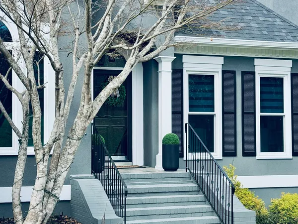 Blue-gray painted exterior with white columns and trim, black shutters and painted brick steps