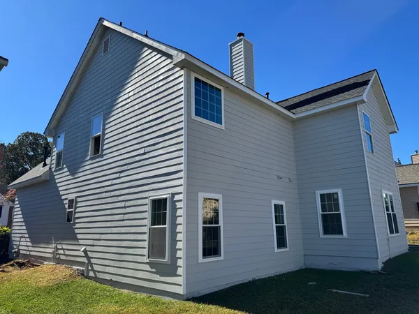 Gray lap siding with white trim and a sided chimney chase